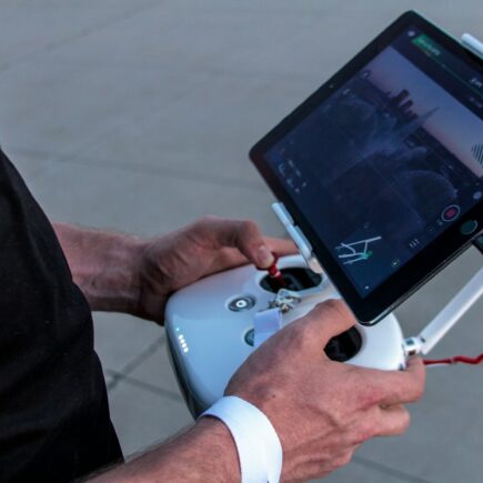 person holding quadcopter controller