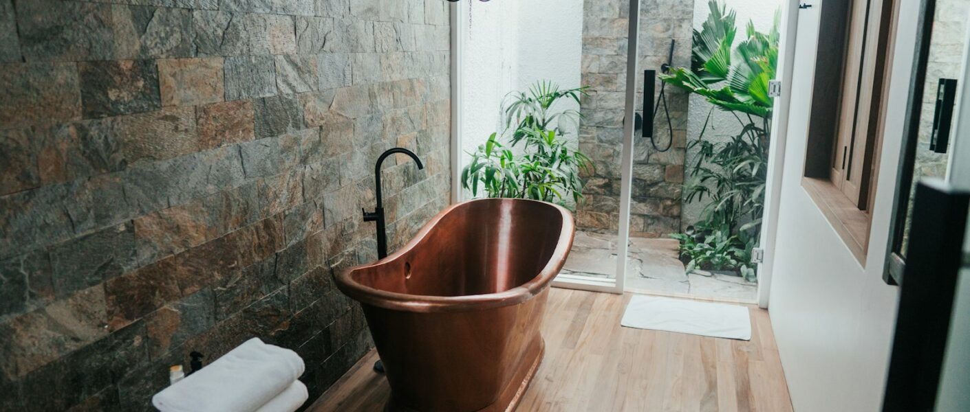 brown plastic bucket near white framed glass door