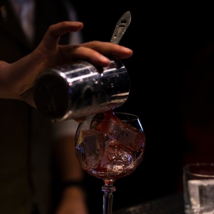 person holding clear wine glass