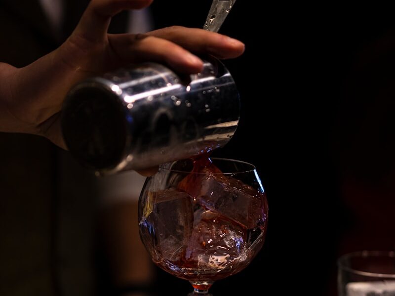 person holding clear wine glass